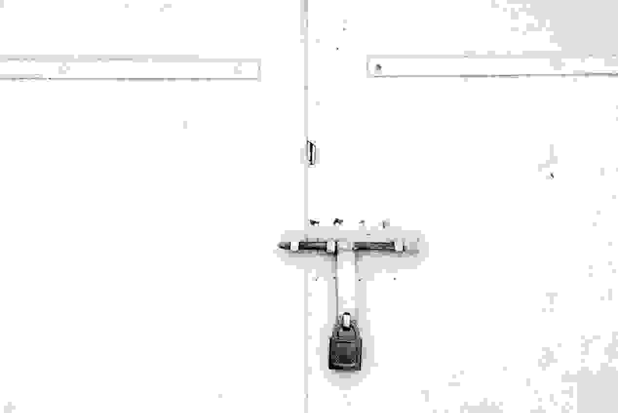 A white door with a padlock attached